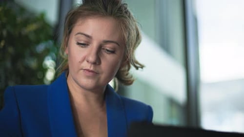 Portrait of a Young Businesswoman Working at a Computer in Office Closeup