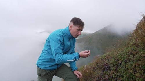 Man Foraging Wild Berries in Mountain Landscape