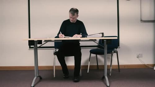 A college professor marks class papers