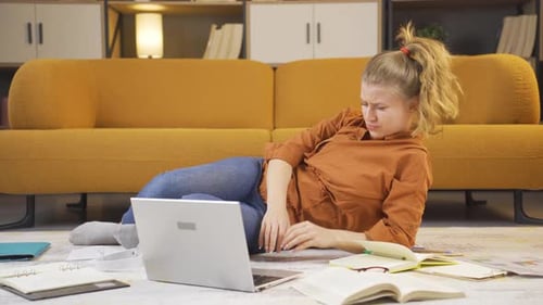 Exhausted Woman Stressed Working from Home on Laptop