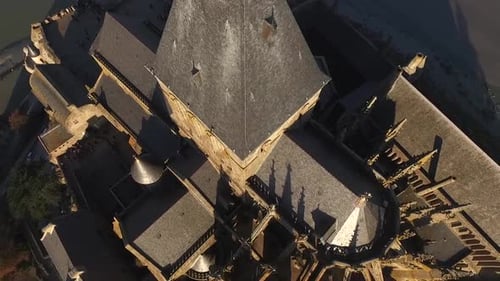 Drone flying over gothic spires and bell tower of Mont Saint-Michel abbey, Normandy in France. Aeria