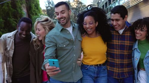 Group of Friends Looking at Cellphone in City