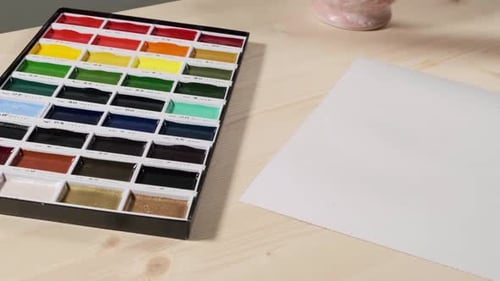 Artist Painting Watercolor Dots on Paper at Table