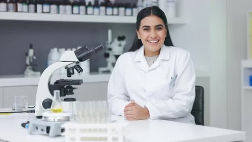 Young biologist analyzing microscopic samples with the latest laboratory tech equipment