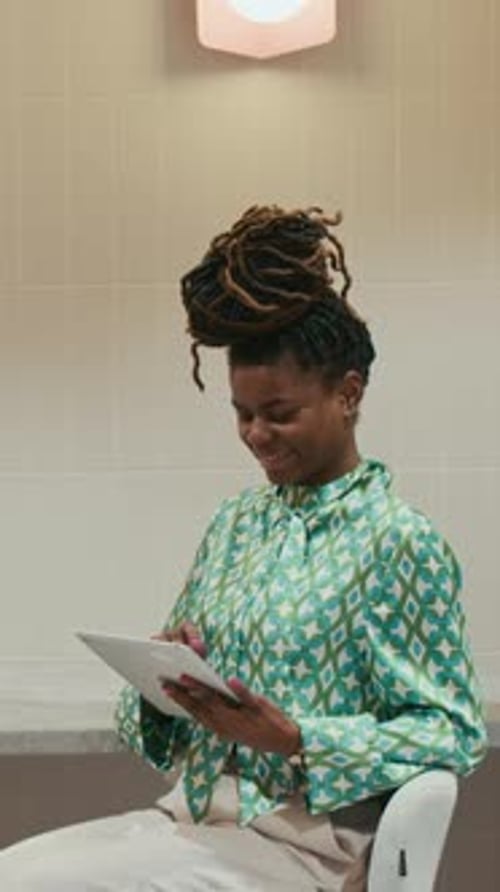 Vertical of Cheerful African American Businesswoman Using Tablet Computer