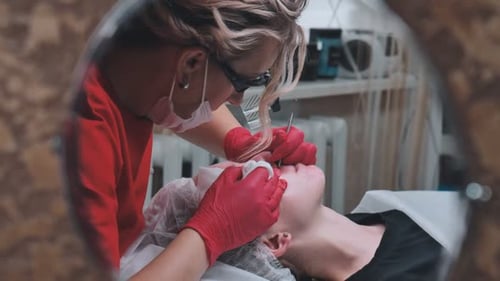 Squeezing Acne From a Girl with Problem Skin in the Salon Using a Loop