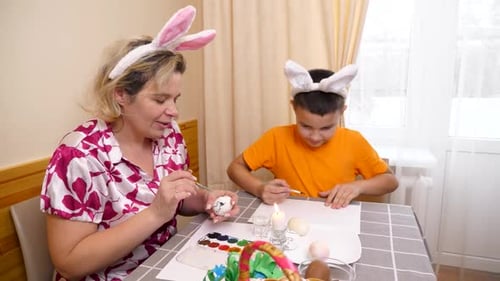 52 1. Mother and son celebrate Easter. They prepare a basket, paint eggs and have fun.