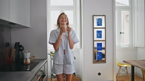 Woman Enjoying Coffee in Sunny Kitchen