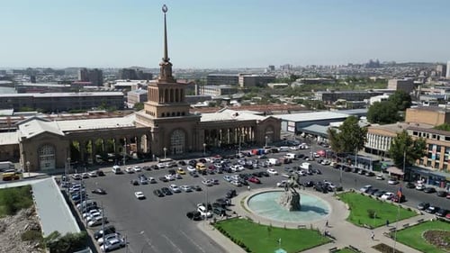 Aerial orbits green plaza in front of Yerevan Railway Station, Armenia