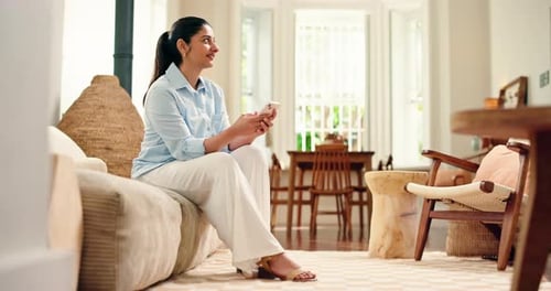 Happy, woman and typing with phone on sofa for text message, social media post and web browsing