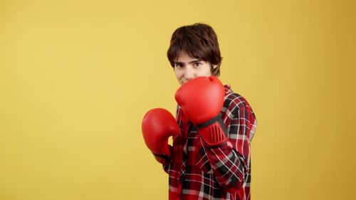 Young Adult Poses With Red Boxing Gloves