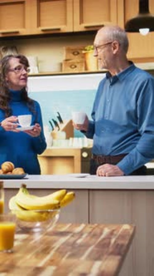 Couple Chatting and Drinking Coffee in Kitchen