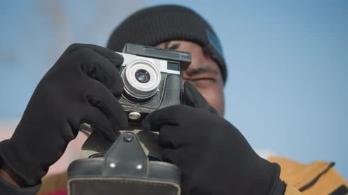 Man Taking Picture with a Vintage Camera