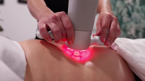 Woman Receiving Red Light Therapy Treatment on Back
