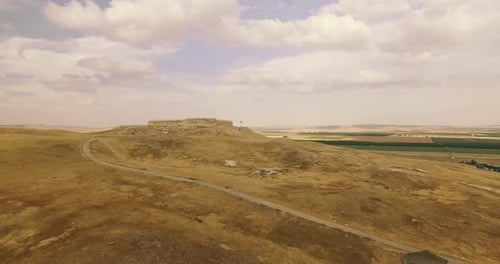 Antiquities in the middle of the Yellow Desert with green grass in the Background