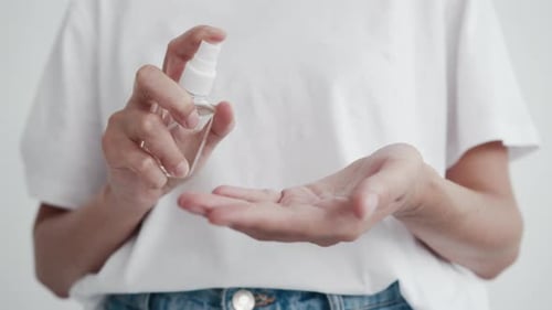 Woman Using Hand Sanitizer for Personal Hygiene