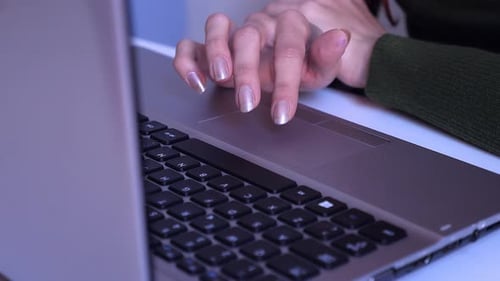 Woman Uses Touchpad on Laptop in Office
