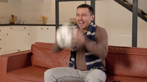 Excited Hearing Impaired Man Watching Soccer on Tv and Celebrating Win