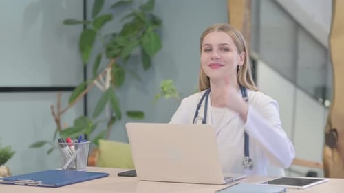 Doctor Woman Types on Laptop and Gives Thumbs Up