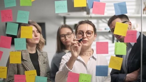 Colleagues Planning and Brainstorming Together in Modern Office