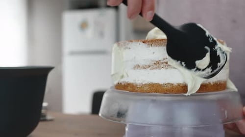 Woman Frosts a Delicious Layer Cake at Home