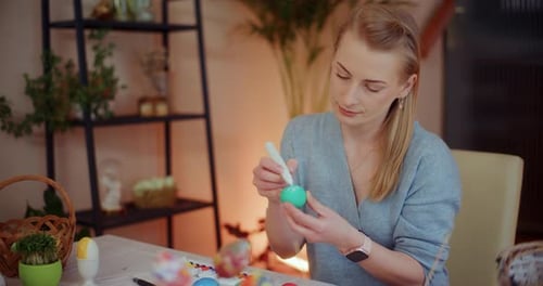 Portrait of Woman Painting Easter Eggs for Easter Holidays