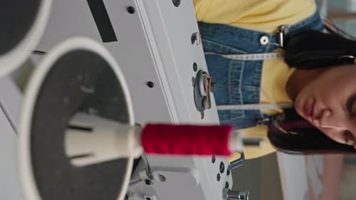 Woman Using Sewing Machine in Fashion Studio