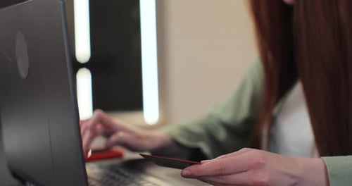Closeup of Young Woman Pressed the Credit Card Code to Pay Online Via the Laptop Commerce Lifestyle
