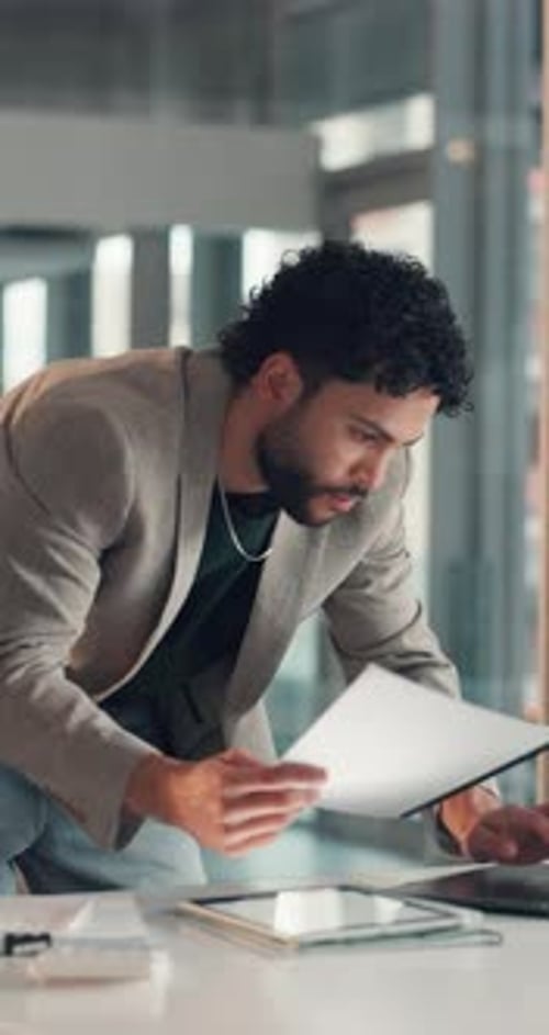 Tablet, laptop and businessman with documents in office with planning for finance report