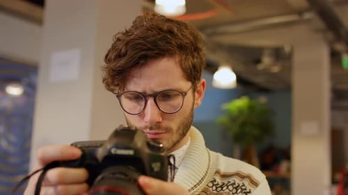 Young Man Examining a Camera