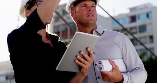 4k video of two architects using a digital tablet while inspecting a building site outdoors