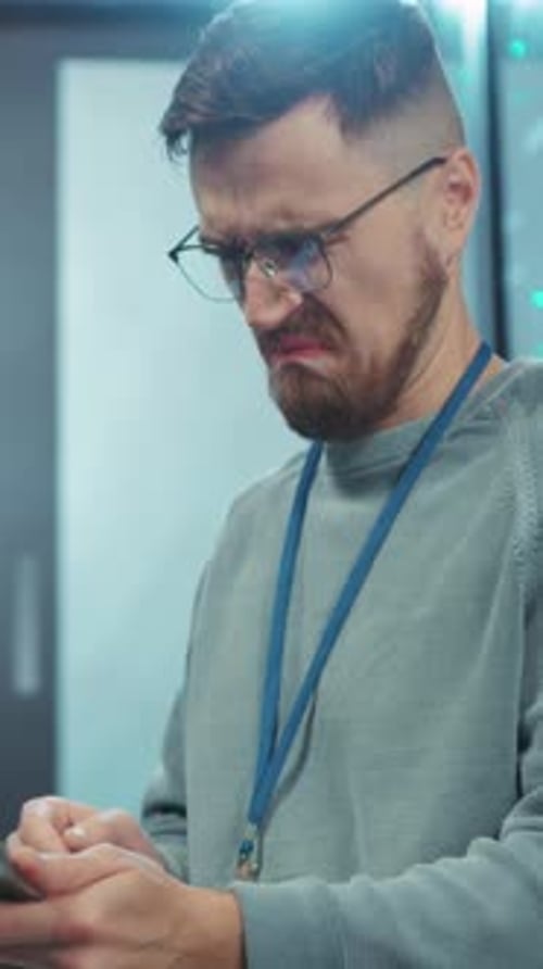 A Young Professional Fully Engaged with a Digital Device While Working in a Modern Office Space