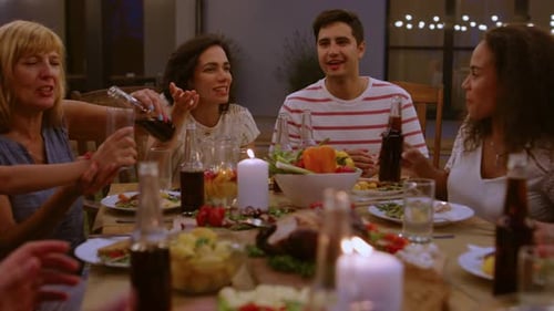 Friends and Family Enjoying Dinner at Backyard Gathering