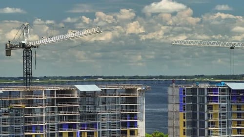 Tower Cranes and Frame Structure of High Residential Apartment Buildings at Construction Site
