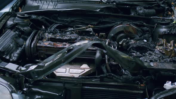 Burnt car engine with charred and melted parts, severe fire damage ...