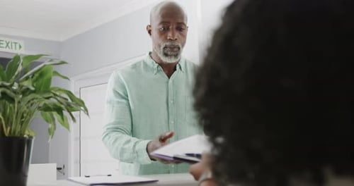 Mature Adult Patient at Clinic Reception Desk
