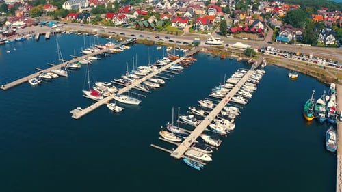 Drone flying arount the marina and moored yachts, boats and motoroboats in Poland