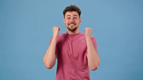 Man Posing With Excited Expressions on Blue Background