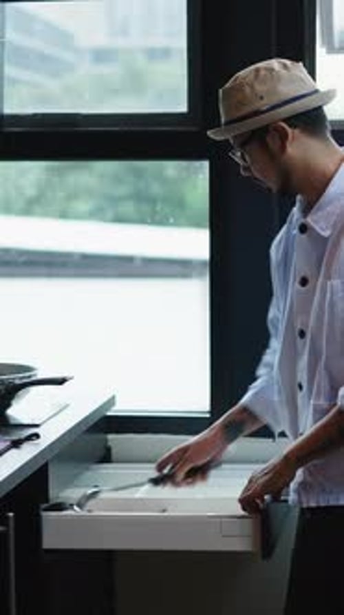 Young Adult Cooking in Modern Kitchen