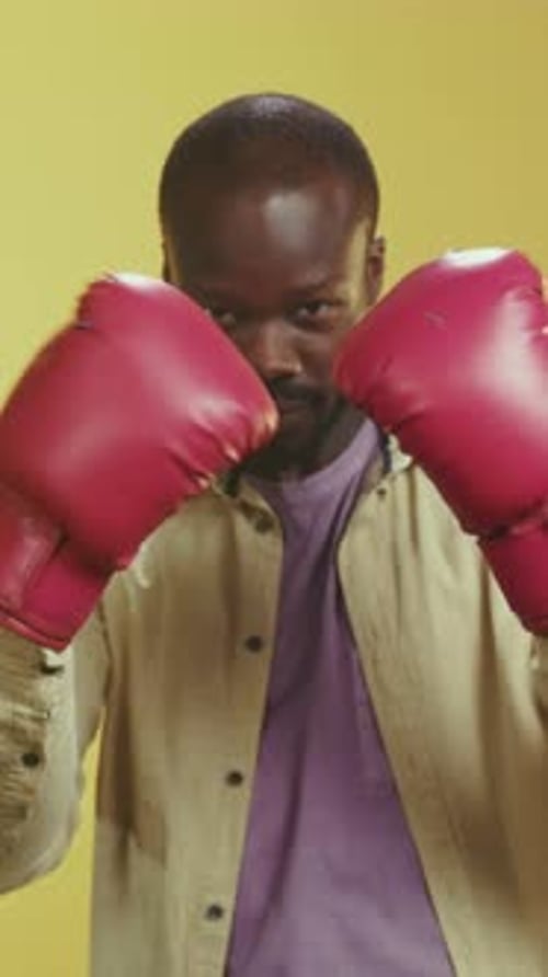 Boxer Trains Indoors Athlete Rehearses Punches in Studio Setting Under Guidance of Coaches and