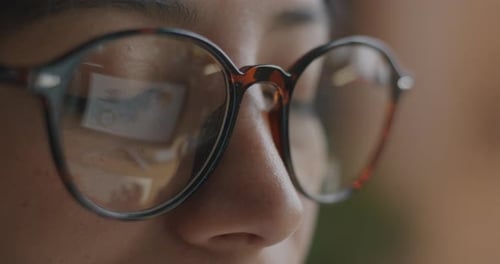 Close Up Of Woman Wearing Glasses With Reflection