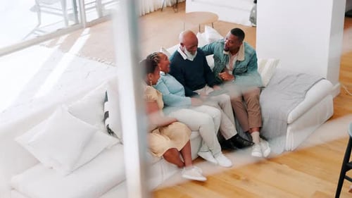 Family Relaxing Together on Couch with Tablet