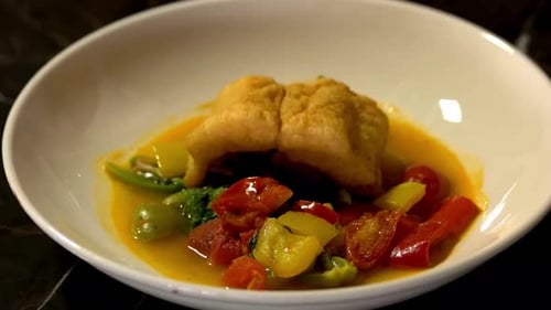 Preparing Enticing Gourmet Dish with Fish and Vegetables