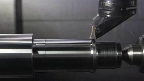 automated CNC lathe shaping metal with precision and accuracy
