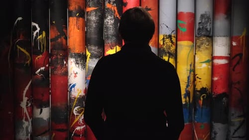 Person in Silhouette Before Colorful Abstract Wall