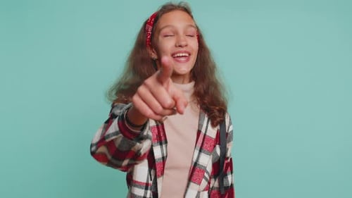 Child Girl Pointing to Camera and Looking with Happy Expression Making Choice Showing Direction