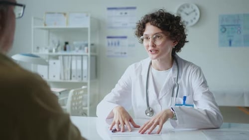 Female Doctor Telling about Treatment Plan to Patient in medical Office
