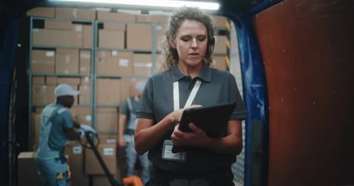 Logistics Warehouse Female Manager with Digital Tablet Scanning Cardboard Boxes Using Scanner