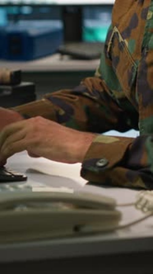 Vertical Video Army Specialist Overseeing National Safety Operations with Devices Close Up