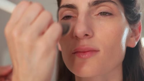 Woman Getting Makeup Applied with a Brush Close-Up